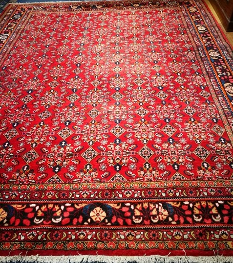 A Persian red ground carpet 400 x 334cm
